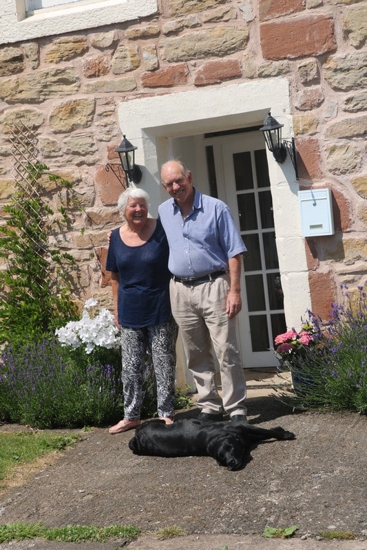 Your Hosts Michael and Fiona, along with one of their black labradors